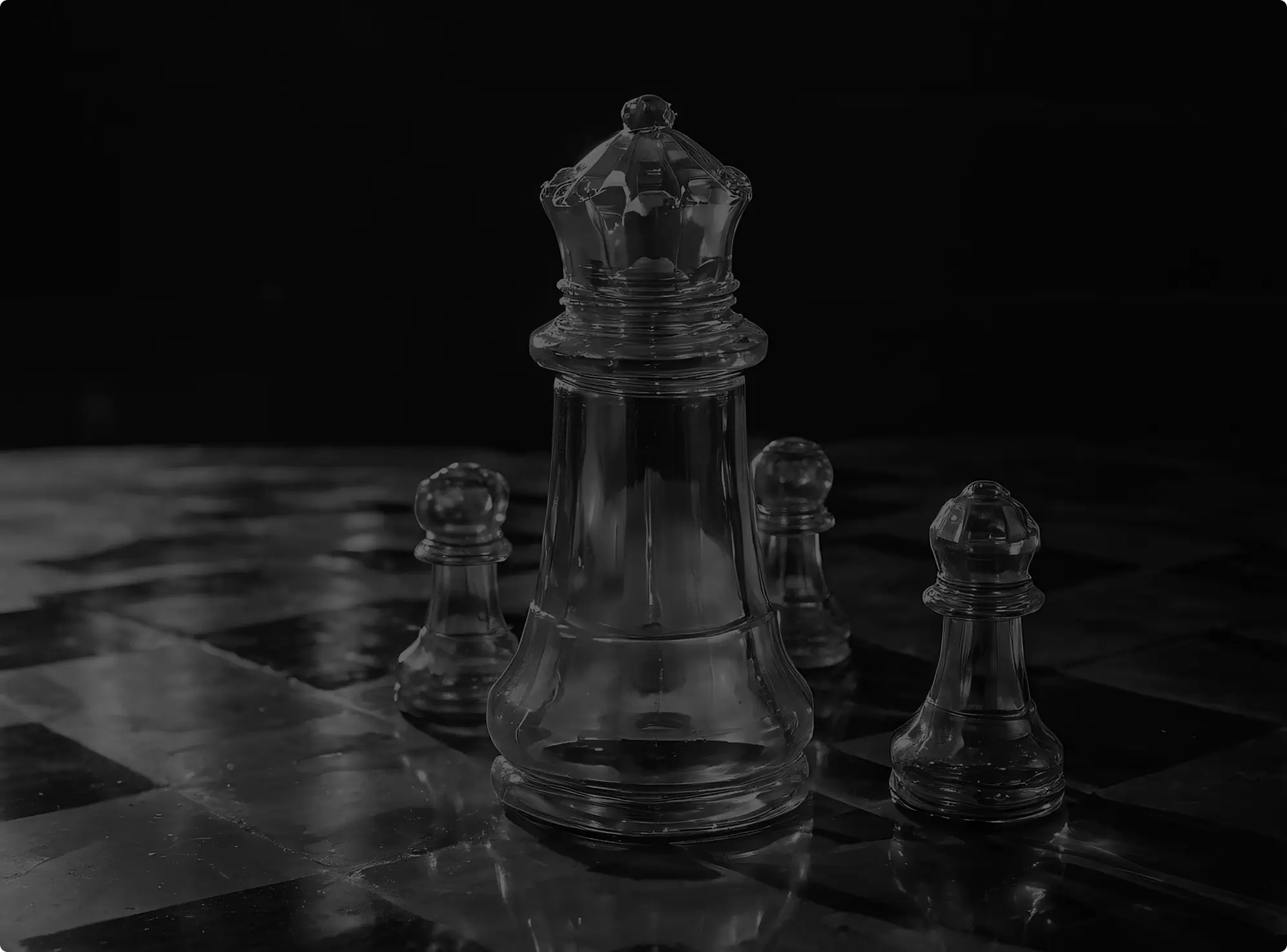 Glass chess queen piece surrounded by three glass pawns on a reflective chessboard.
